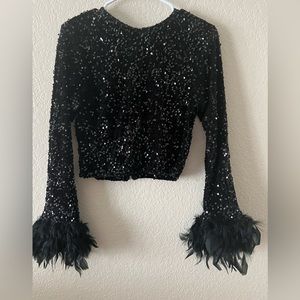 Brand new, handmade, black sequin blouse with feather. Size 6 or 8.